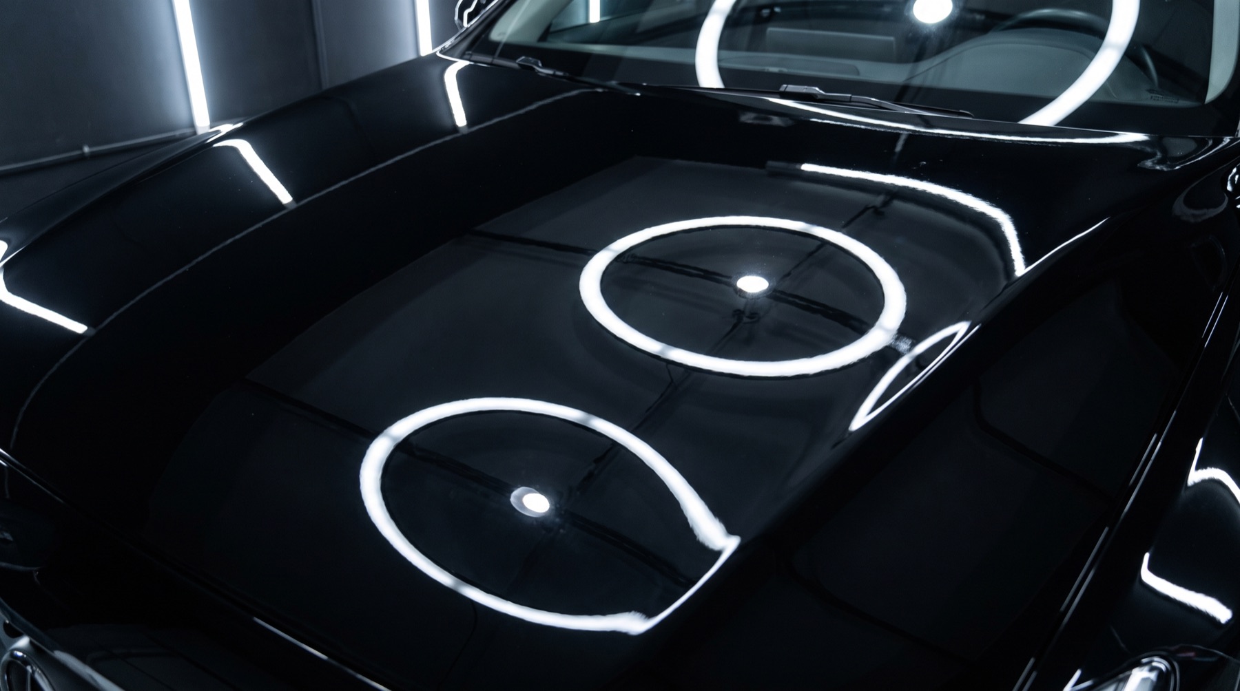 After: the same bonnet machine-polished to a flawless mirror finish reflecting the studio ring lights